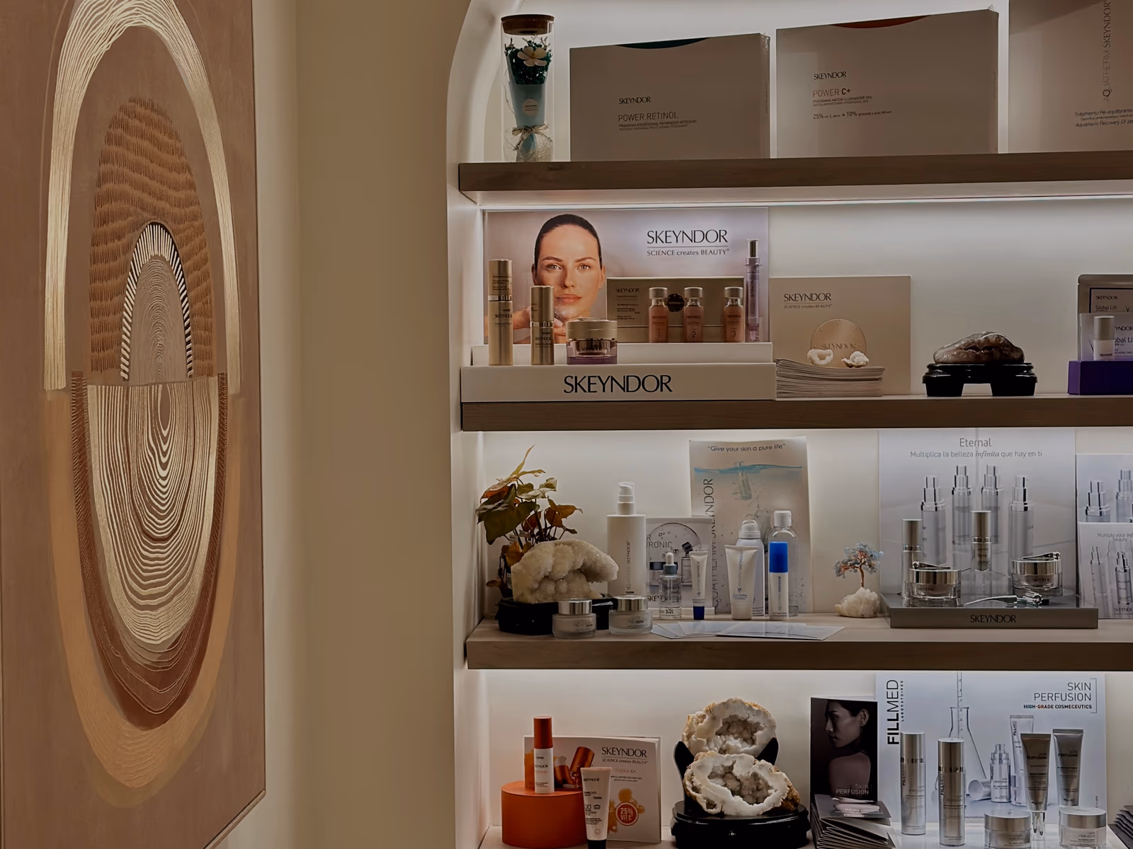 An arched alcove of curated skincare shelves beside a circular woven artwork at Bötaniqa